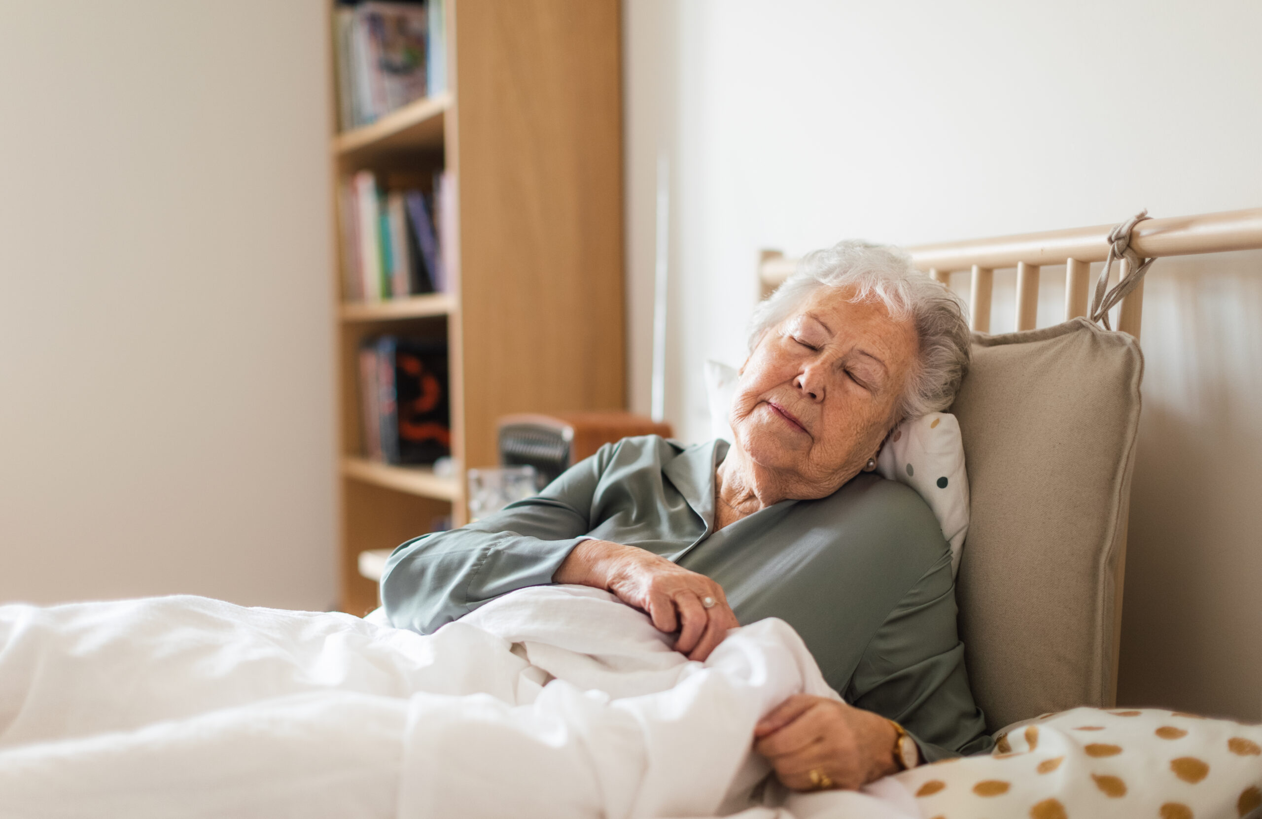Senior woman sleeping in her bed alone.